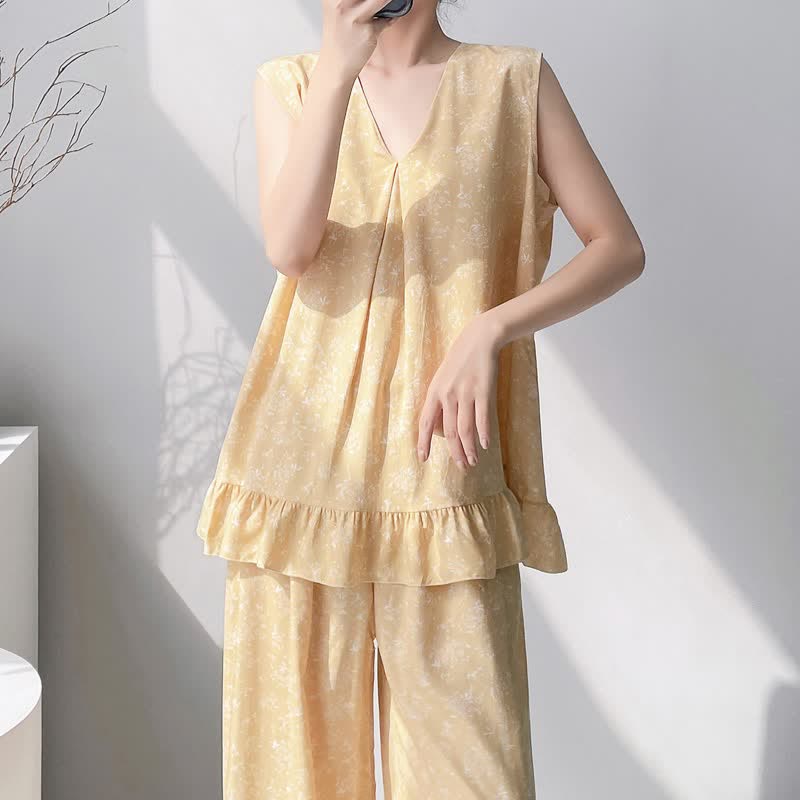 Pigiama composto da canotta e pantaloni con motivo floreale giallo a foglie. - image 4
