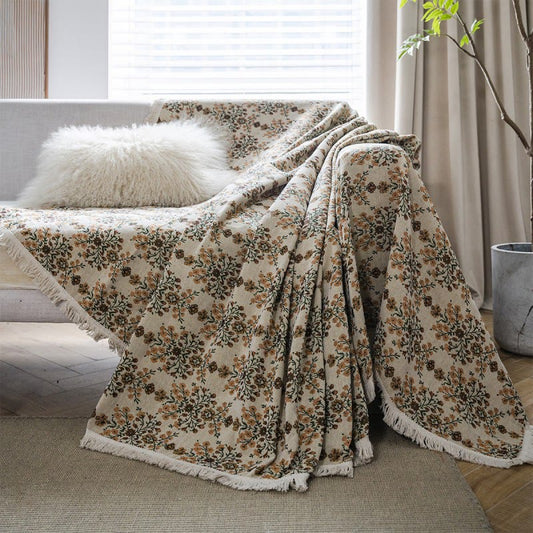Copridivano con nappa in jacquard a fiori di prugna