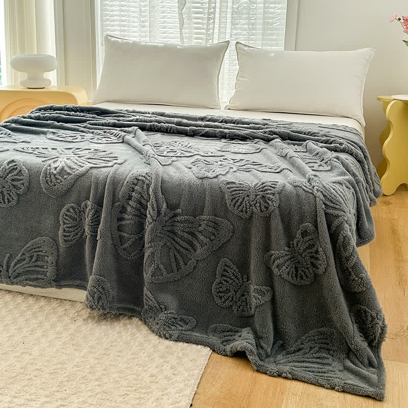 Coperta in pile reversibile con motivo a farfalla in tinta unita