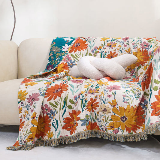 Coperta reversibile in garza di cotone con nappa floreale brillante