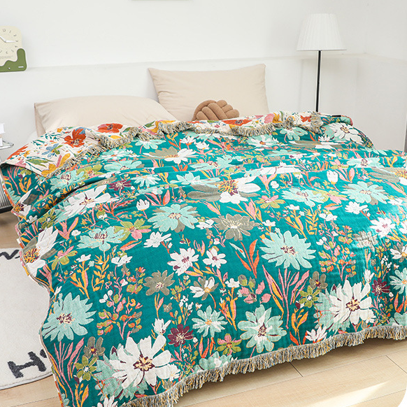 Coperta reversibile in garza di cotone con nappa floreale brillante