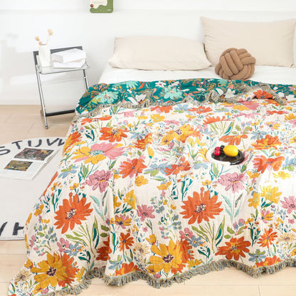 Coperta reversibile in garza di cotone con nappa floreale brillante