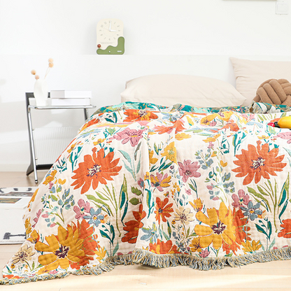Trapunta reversibile in garza di cotone con nappa floreale luminosa