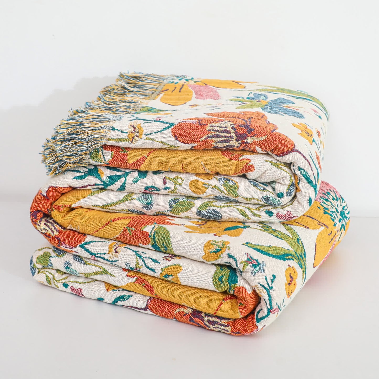 Coperta reversibile in garza di cotone con nappa floreale brillante
