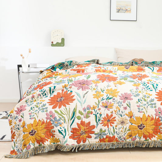 Trapunta reversibile in garza di cotone con nappa floreale luminosa