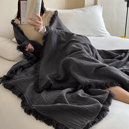 Coperta in garza di cotone con nappe in tinta unita semplice