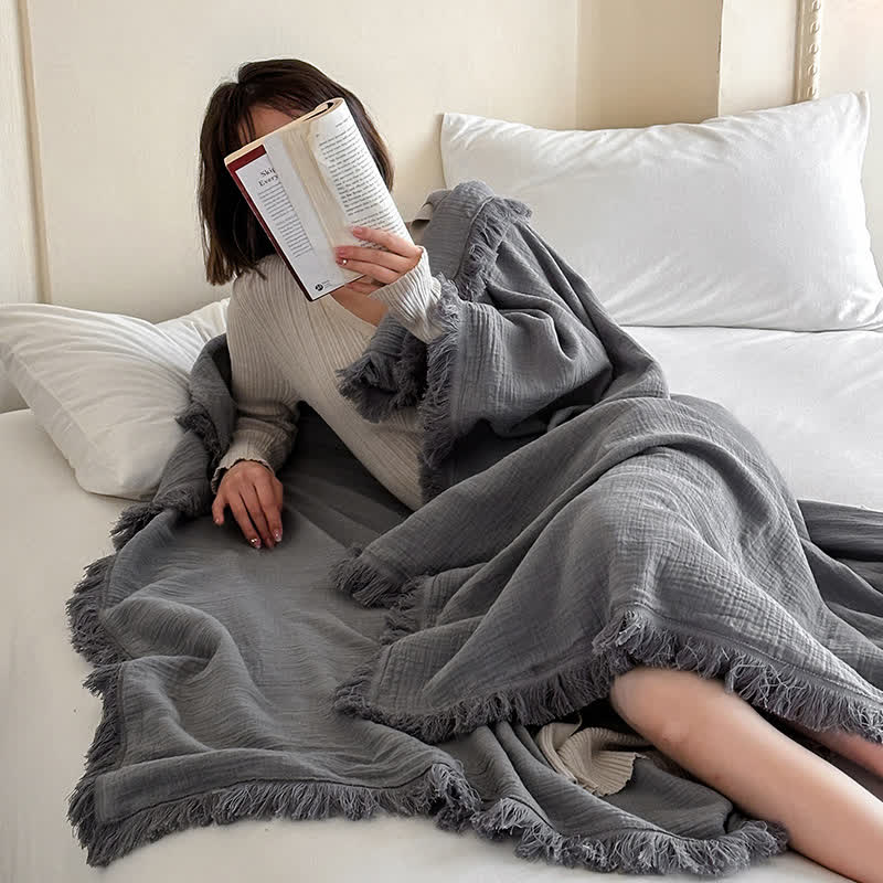 Coperta in garza di cotone con nappe in tinta unita semplice