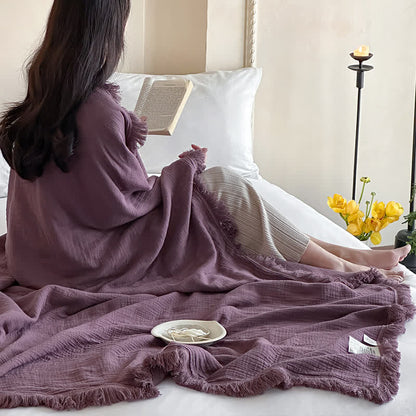 Coperta in garza di cotone con nappe in tinta unita semplice