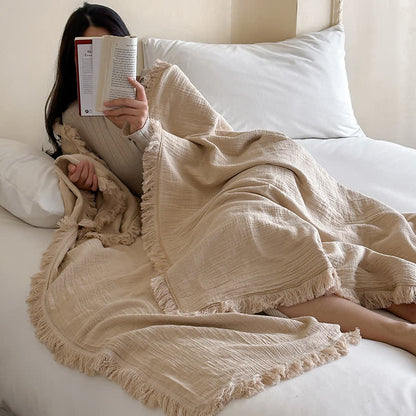 Coperta in garza di cotone con nappe in tinta unita semplice