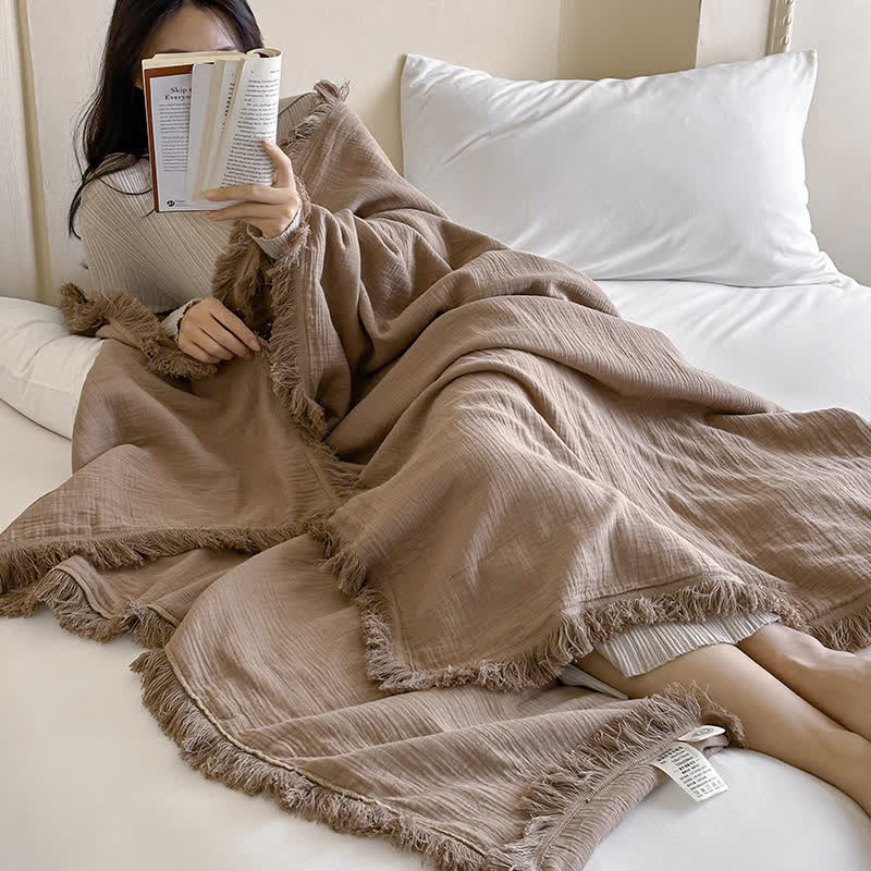 Coperta in garza di cotone con nappe in tinta unita semplice