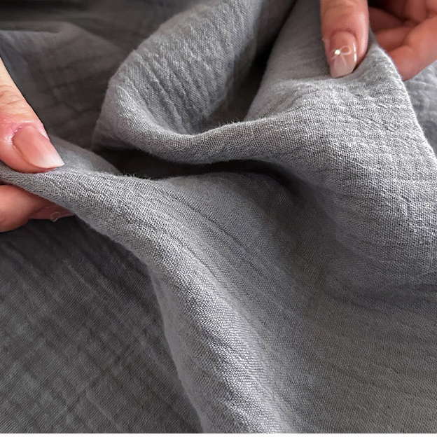 Coperta in garza di cotone con nappe in tinta unita semplice