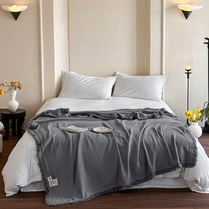 Coperta in garza di cotone con nappe in tinta unita semplice