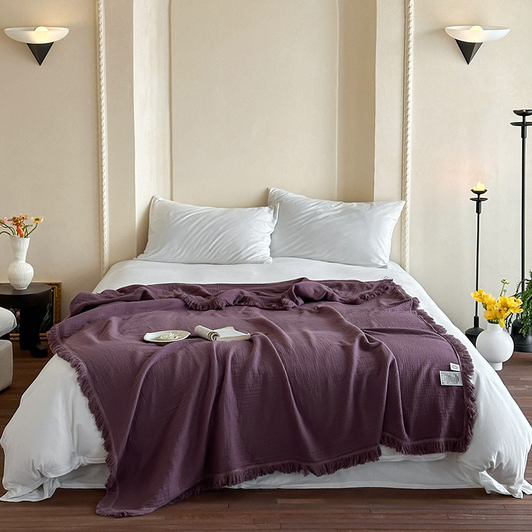 Coperta in garza di cotone con nappe in tinta unita semplice