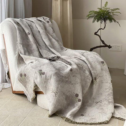 Coperta per divano con nappe in garza reversibile tinta in filo
