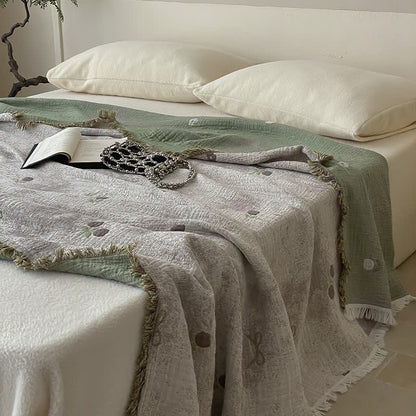 Coperta per divano con nappe in garza reversibile tinta in filo