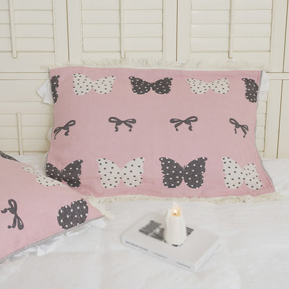 Trapunta con fiocco a farfalla in puro cotone garzato e nappe morbide
