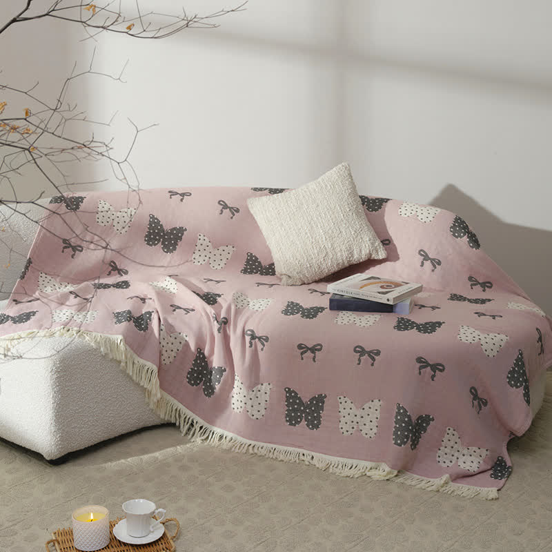 Trapunta con fiocco a farfalla in puro cotone garzato e nappe morbide