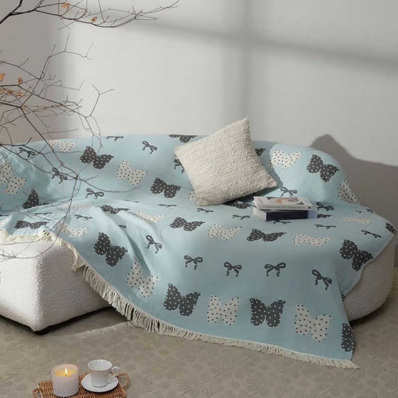 Trapunta con fiocco a farfalla in puro cotone garzato e nappe morbide