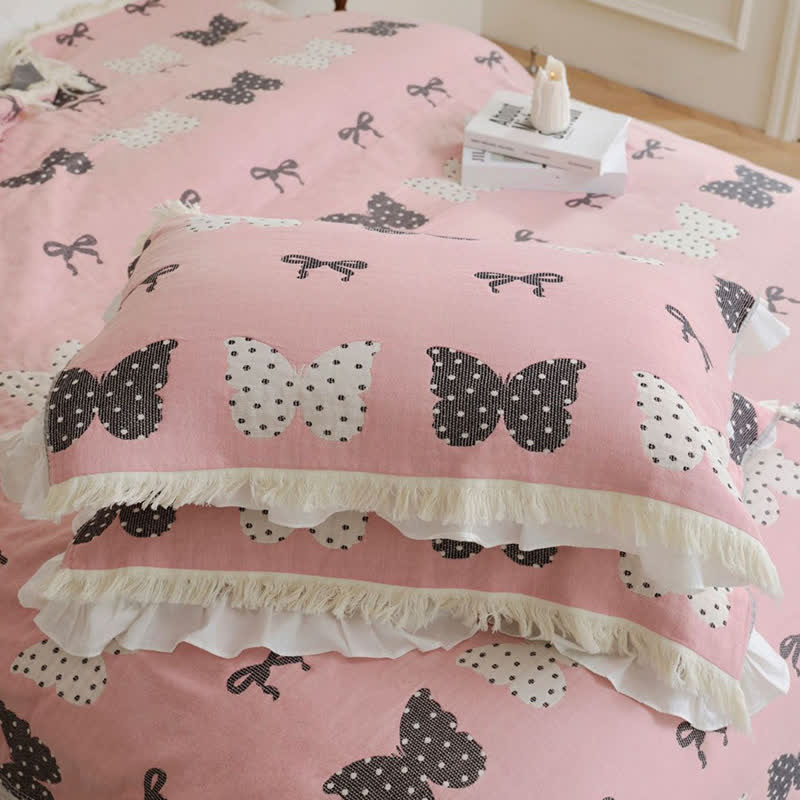 Trapunta con fiocco a farfalla in puro cotone garzato e nappe morbide
