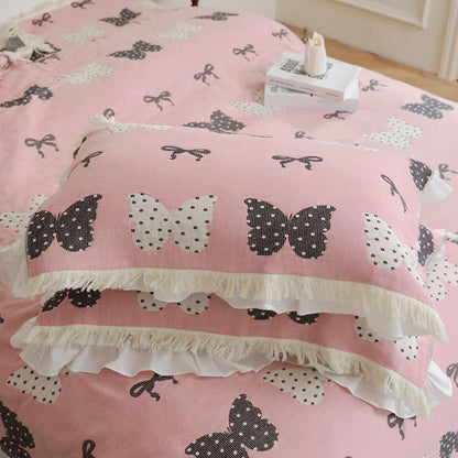 Trapunta con fiocco a farfalla in puro cotone garzato e nappe morbide