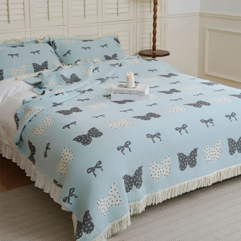 Trapunta con fiocco a farfalla in puro cotone garzato e nappe morbide