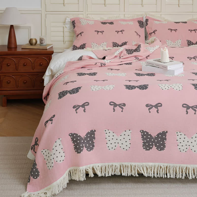 Trapunta con fiocco a farfalla in puro cotone garzato e nappe morbide