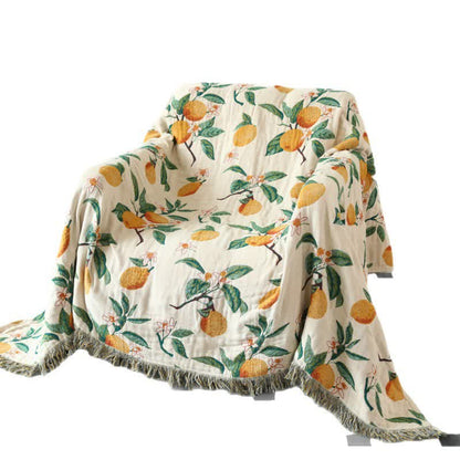 Coperta reversibile in garza di cotone con stampa limone e nappe