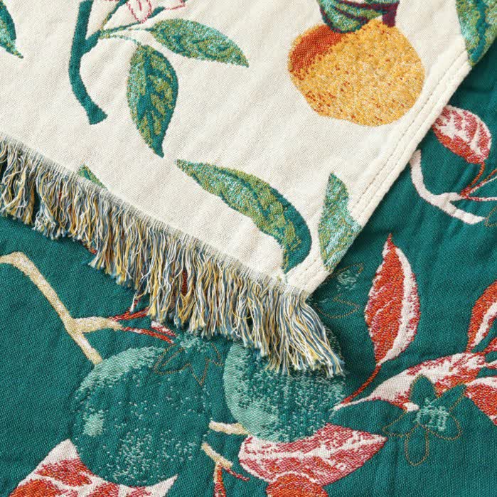 Coperta reversibile in garza di cotone con stampa limone e nappe