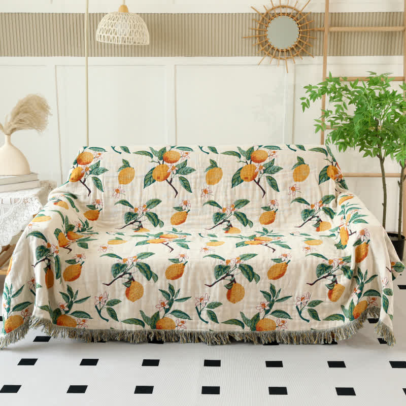 Coperta reversibile in garza di cotone con stampa limone e nappe