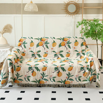 Coperta reversibile in garza di cotone con stampa limone e nappe
