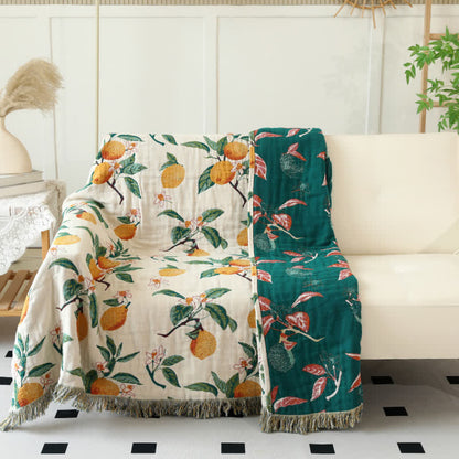 Coperta reversibile in garza di cotone con stampa limone e nappe