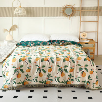 Coperta reversibile in garza di cotone con stampa limone e nappe