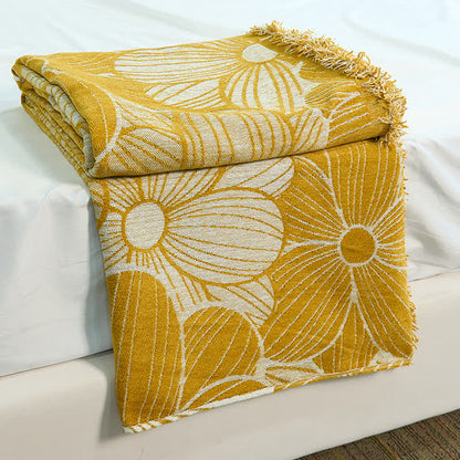 Coperta in ciniglia jacquard con nappe e motivo a margherita