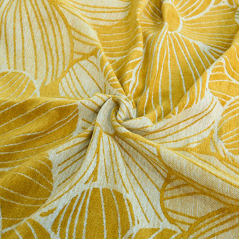 Coperta in ciniglia jacquard con nappe e motivo a margherita