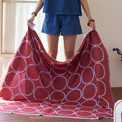Coperta reversibile con motivo a cerchi e nappe - image 4