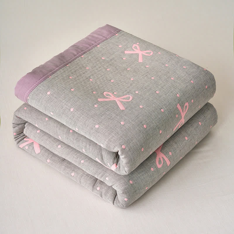 Trapunta reversibile in garza di cotone jacquard con motivo a fiocco - image 1