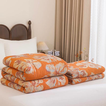 Trapunta reversibile in cotone con fiori arancioni e blu - image 1