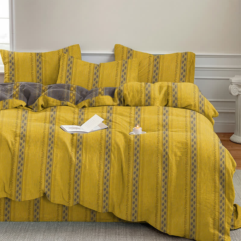 Set di biancheria da letto con copripiumino reversibile in cotone a righe e motivo a foglie. - image 1