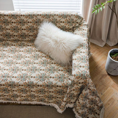 Copridivano con nappa in jacquard a fiori di prugna
