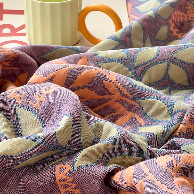 Trapunta reversibile in cotone con foglie verdi e arancioni