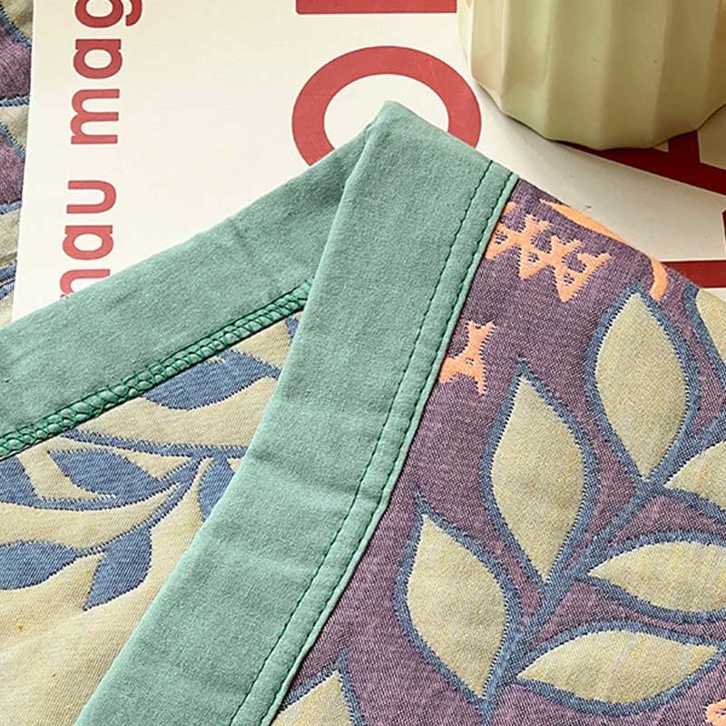 Trapunta reversibile in cotone con foglie verdi e arancioni